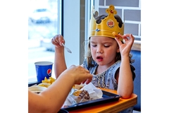 Image Girl eating fries at Burger King.